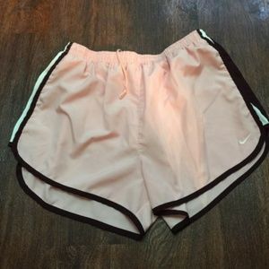 Pink Nike track shorts with maroon & white stripes